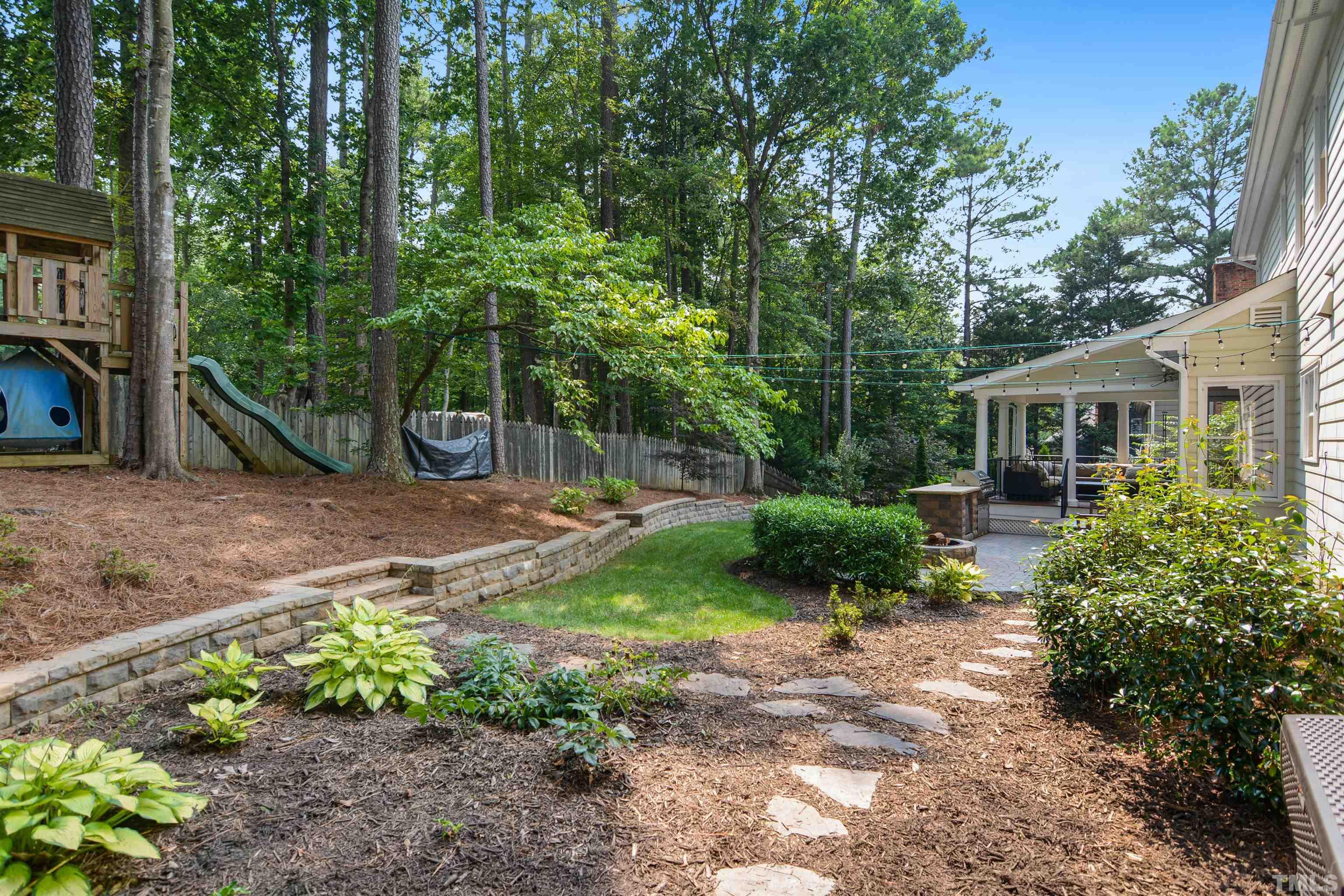 3005 Dunkirk Drive Raleigh, NC 27613 - Photo 34 of 35 a backyard of a house with lots of green space