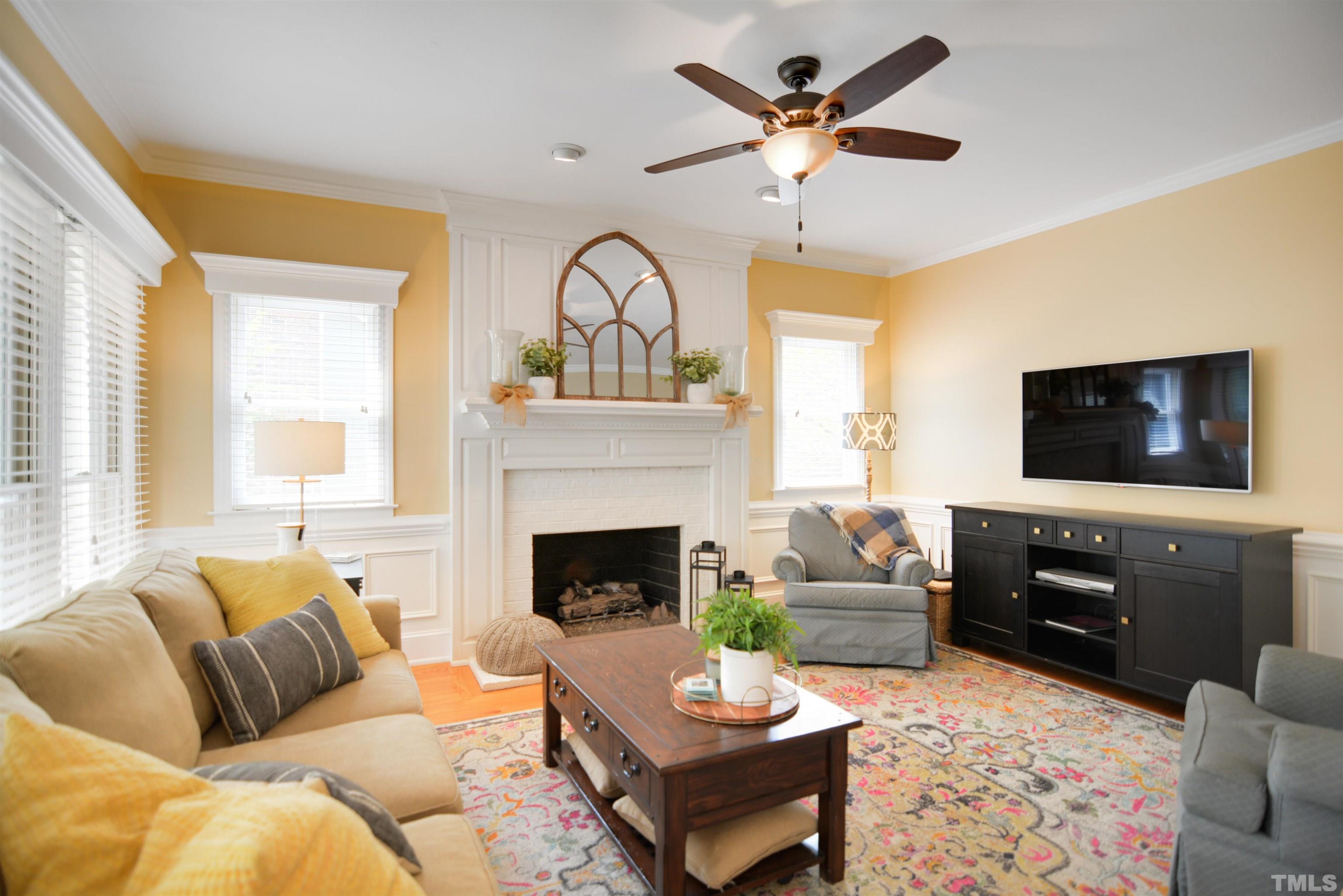 3005 Dunkirk Drive Raleigh, NC 27613 - Photo 7 of 35 a living room with furniture fireplace and a flat screen tv