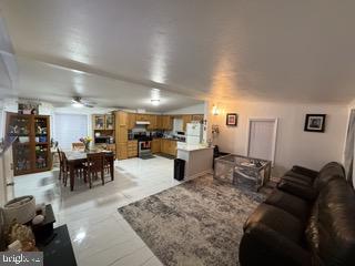 181 Cookstown New Egypt Road, Unit B37 Wrightstown, NJ 08562 - Photo 2 of 12 a living room with furniture a wooden floor and kitchen view