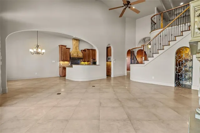 a view of a livingroom with wooden floor and a chandelier