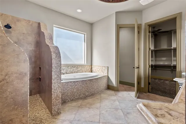 a bathroom with a bathtub and a shower