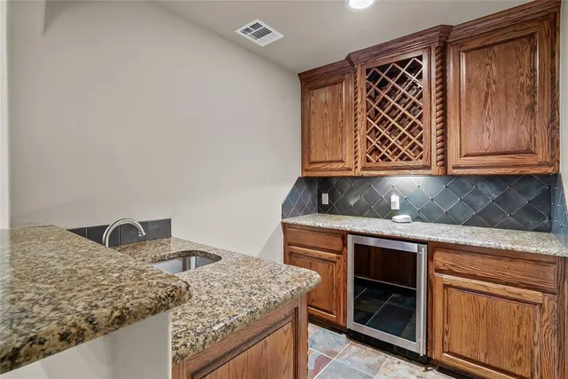an empty room with a window and a ceiling fan