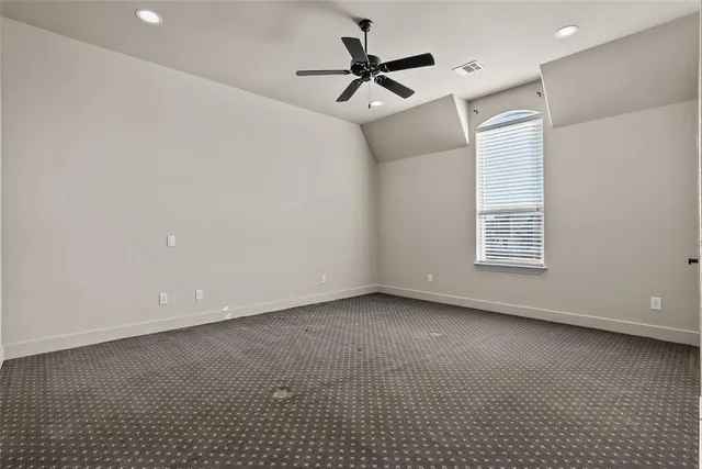 a view of a livingroom with a ceiling fan and window