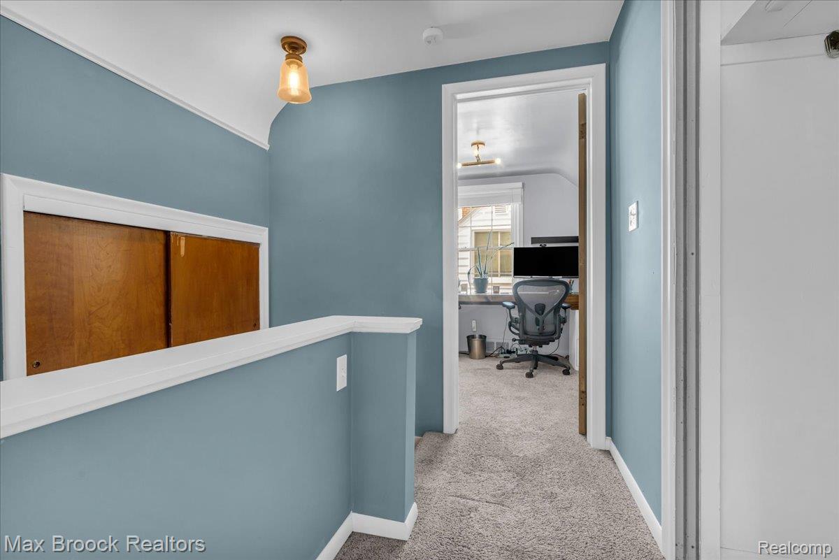 3711 Normandy Road Royal Oak, MI 48073 - Photo 22 of 40 Hall with carpet flooring, an office area, vaulted ceiling, and an upstairs landing