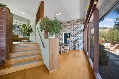 a view of entryway and hall with wooden floor