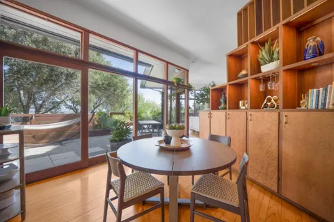 a view of a dining room with furniture window and wooden floor