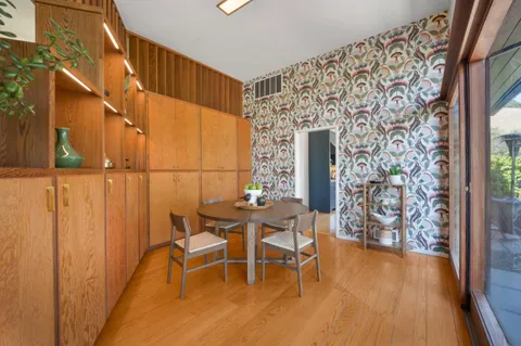 a dining room with furniture and wooden floor