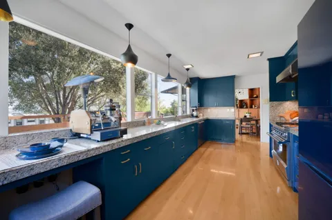 a kitchen with granite countertop lots of counter top space and dining table