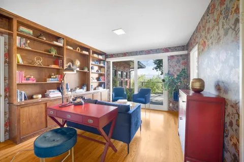 a living room with furniture a rug and a large window