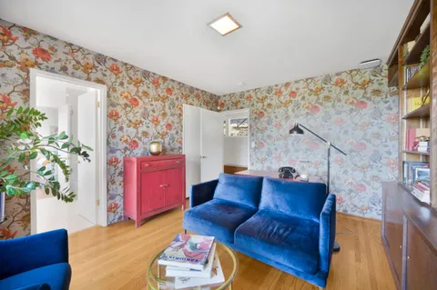 a living room with furniture and flowers