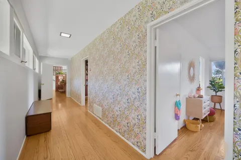 workspace with wooden floor and a bathroom