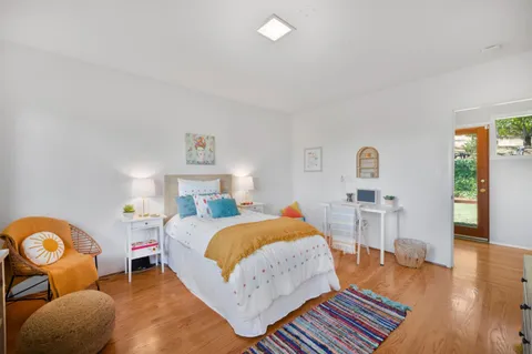 a bed room with a bed and a chair