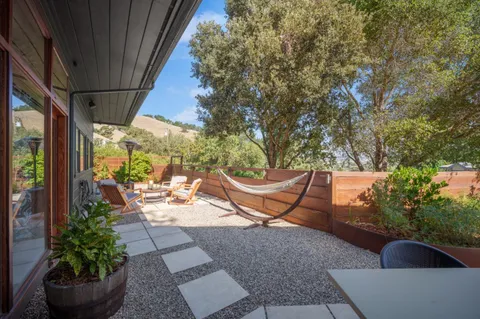 a view of a porch with furniture and plants