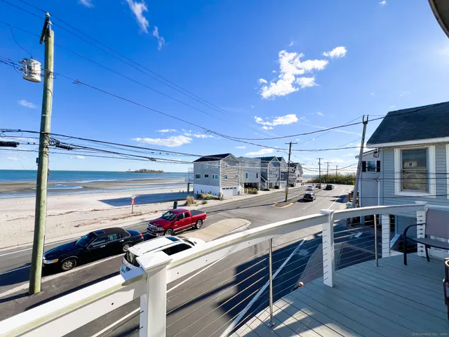 a kitchen with kitchen island granite countertop a sink cabinets and wooden floor