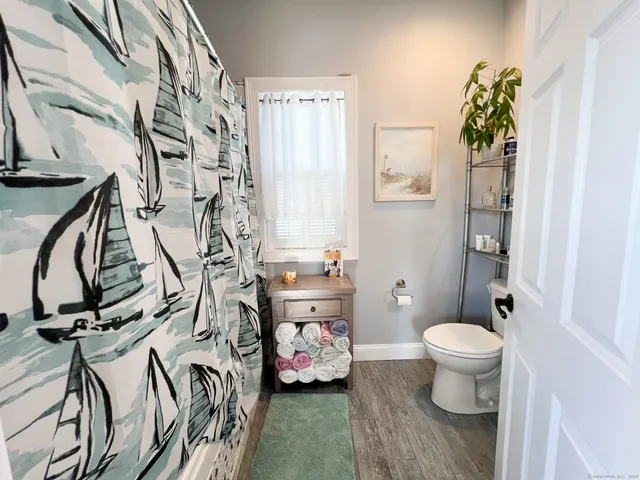 a bathroom with a bathtub and mirror