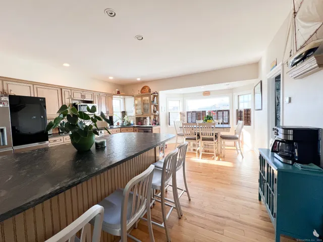 a kitchen with a table chairs refrigerator and microwave