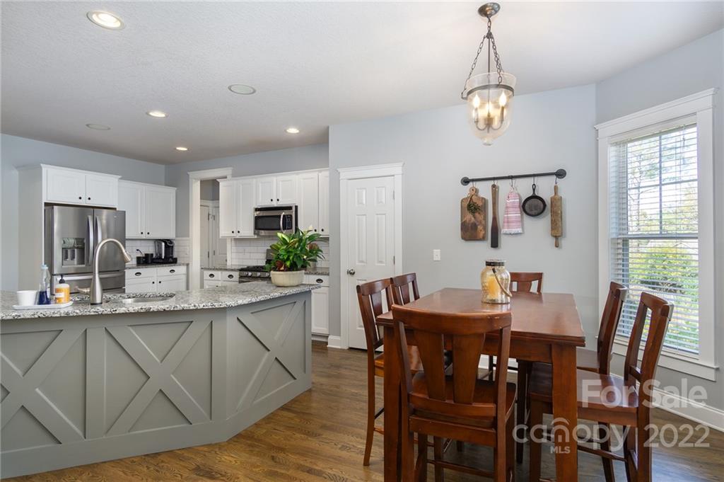 225 Nut Hatch Loop Arden, NC 28704 - Photo 11 of 48 a view of a dining room with furniture window and wooden floor