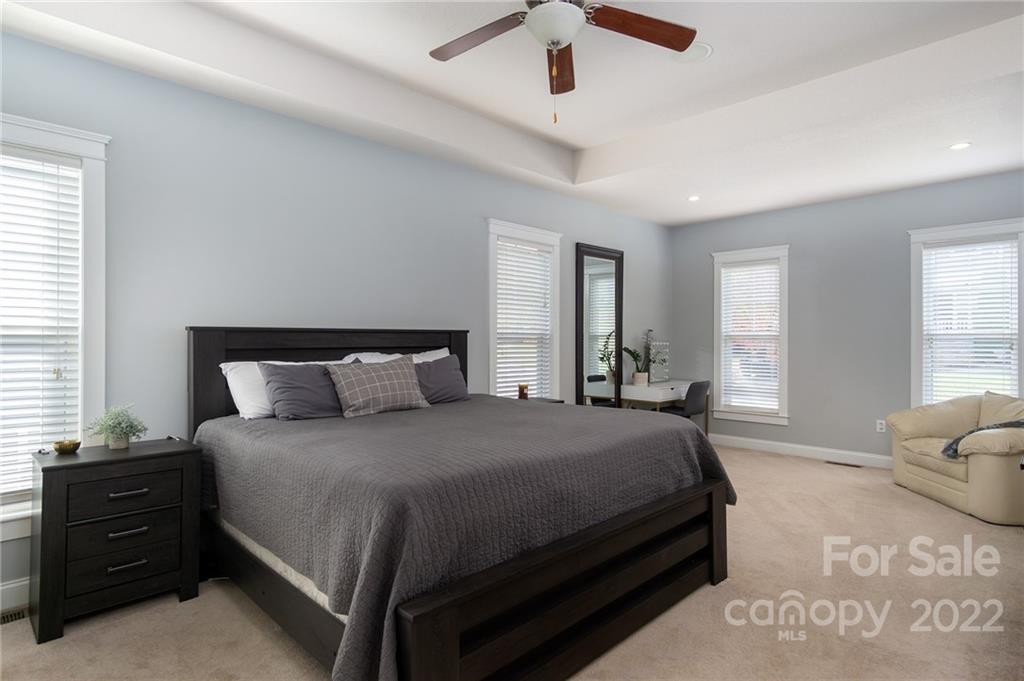 225 Nut Hatch Loop Arden, NC 28704 - Photo 16 of 48 a bedroom with a bed and wooden floor