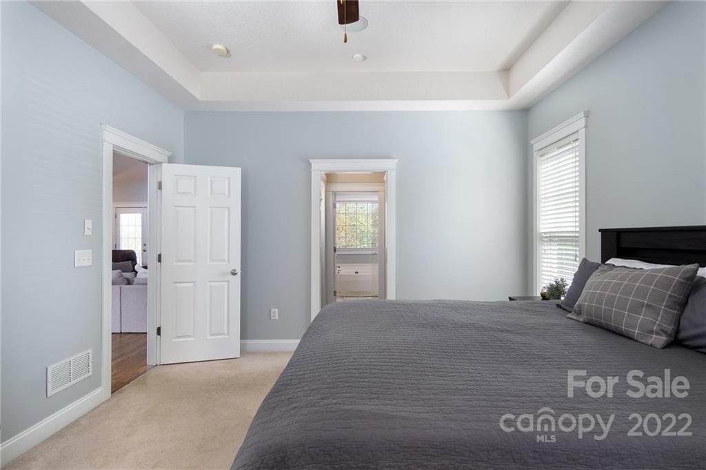 225 Nut Hatch Loop Arden, NC 28704 - Photo 18 of 48 a bedroom with a bed and window