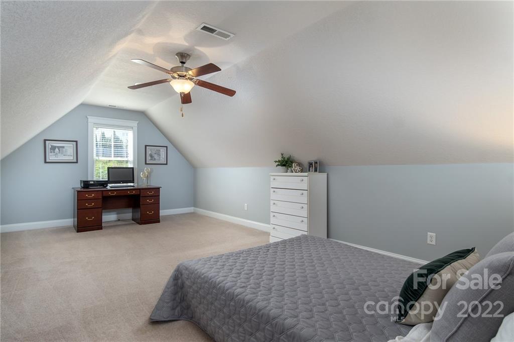 225 Nut Hatch Loop Arden, NC 28704 - Photo 24 of 48 a bedroom with furniture and a ceiling fan