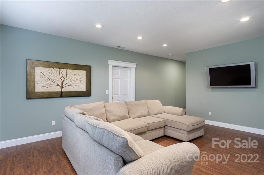 225 Nut Hatch Loop Arden, NC 28704 - Photo 29 of 48 a living room with furniture and a flat screen tv