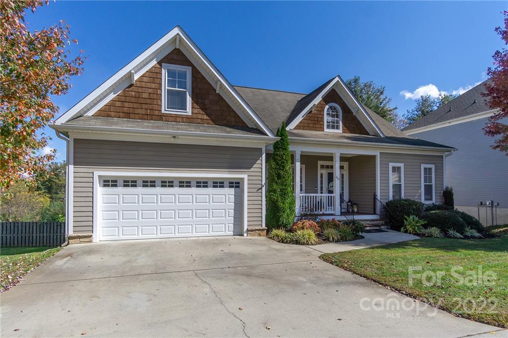 225 Nut Hatch Loop Arden, NC 28704 - Photo 3 of 48 a front view of a house with garden