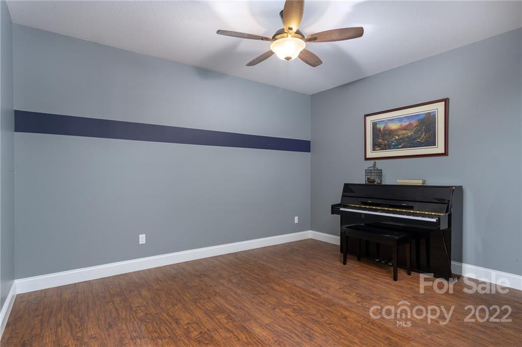 225 Nut Hatch Loop Arden, NC 28704 - Photo 35 of 48 a view of room with a piano and wooden floor
