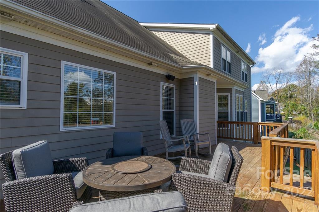 225 Nut Hatch Loop Arden, NC 28704 - Photo 39 of 48 a view of a patio with couches chairs and wooden floor