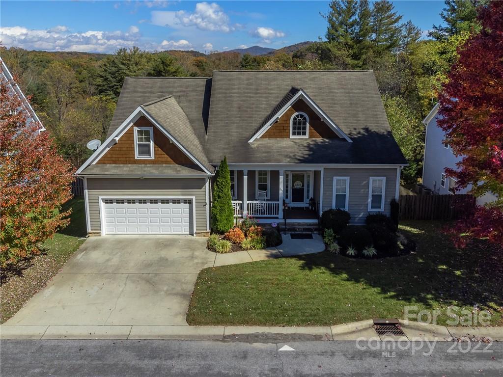225 Nut Hatch Loop Arden, NC 28704 - Photo 41 of 48 a front view of a house with a yard and outdoor seating