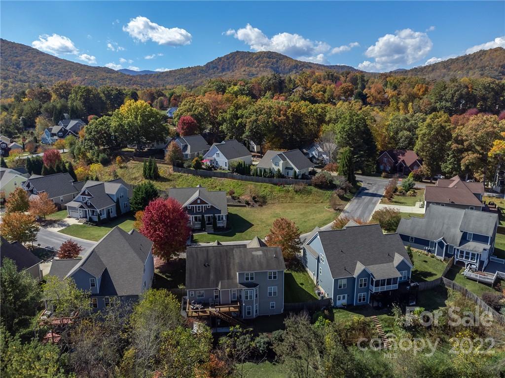 225 Nut Hatch Loop Arden, NC 28704 - Photo 44 of 48 an aerial view of a house with a garden and lake view