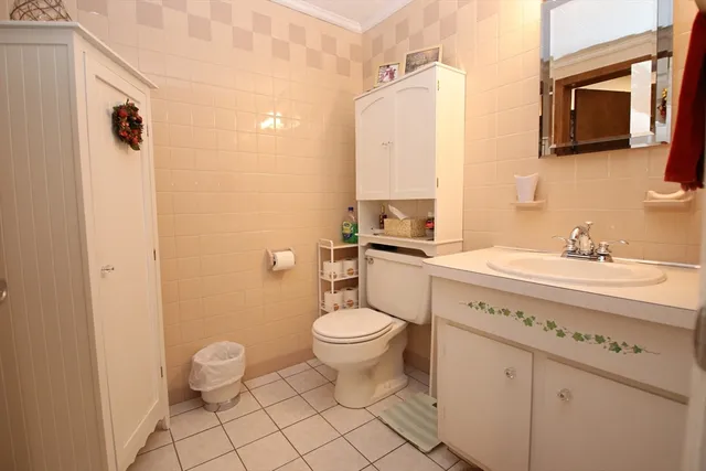 a bathroom with a sink a toilet and mirror