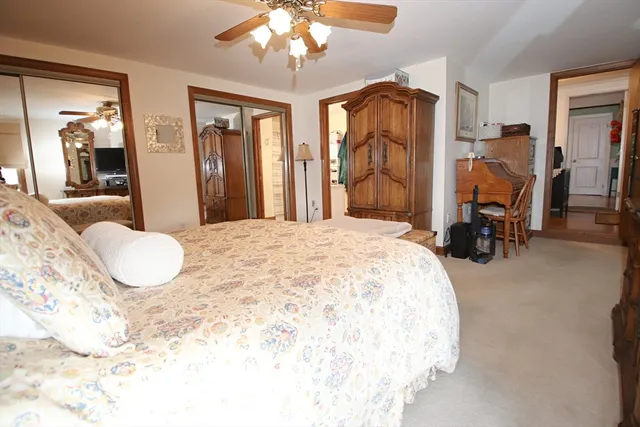a bedroom with bed and glass door