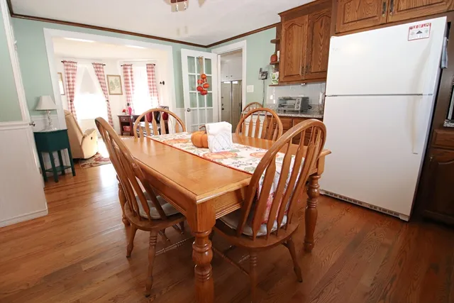 a dining room with furniture a window and wooden floor