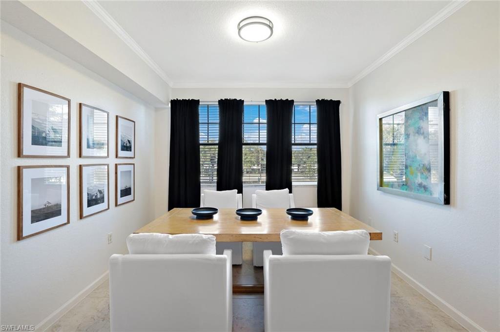 13010 Positano Circle, Unit 203 Naples, FL 34105 - Photo 5 of 22 a dining room with furniture and window