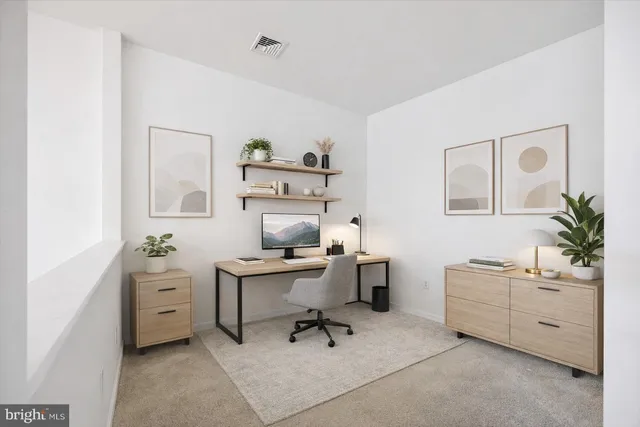 a workspace with a desk chair and painted walls