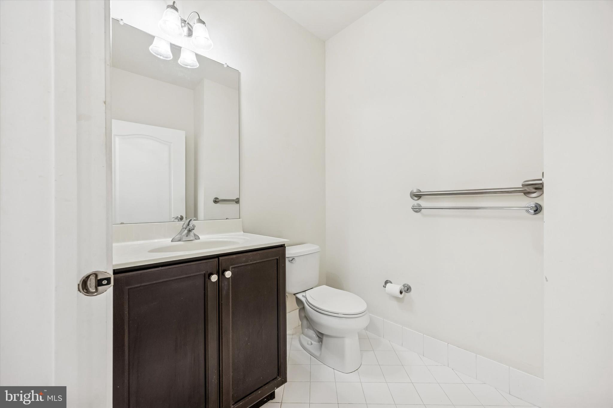 427 Carson Terrace Huntingdon Valley, PA 19006 - Photo 7 of 19 a bathroom with a toilet a sink a mirror and vanity