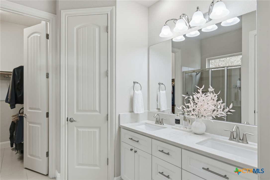 2608 Barbera Pass Austin, TX 78748 - Photo 12 of 39 a bathroom with a sink mirror and a shower