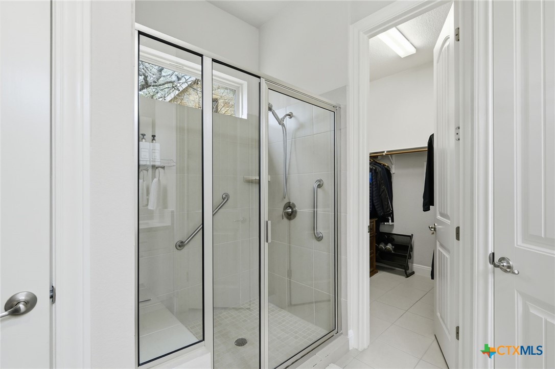 2608 Barbera Pass Austin, TX 78748 - Photo 13 of 39 a bathroom with a shower and a glass door