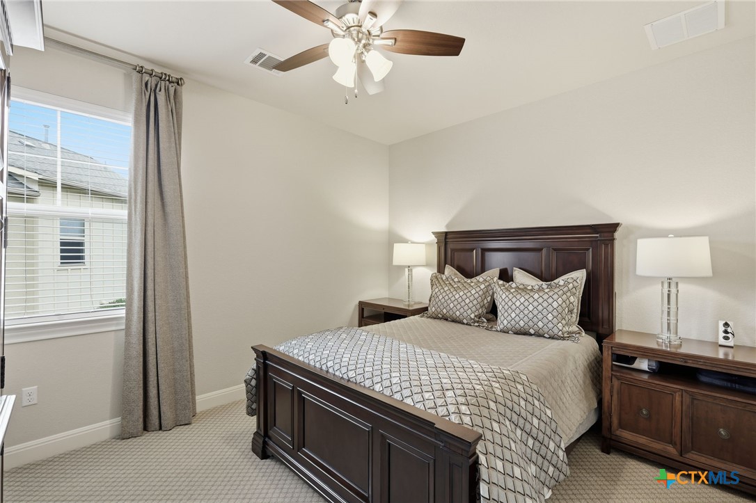 2608 Barbera Pass Austin, TX 78748 - Photo 18 of 39 a bedroom with a bed and a night stand