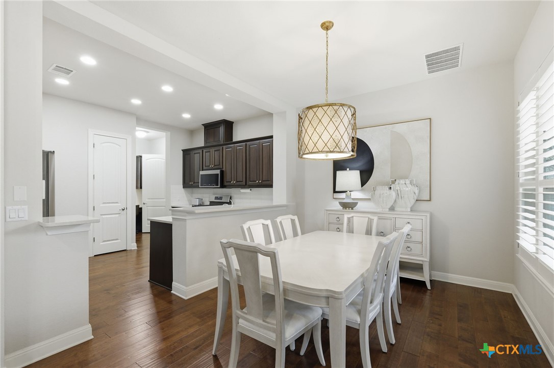 2608 Barbera Pass Austin, TX 78748 - Photo 7 of 39 a view of a dining room with furniture window and wooden floor