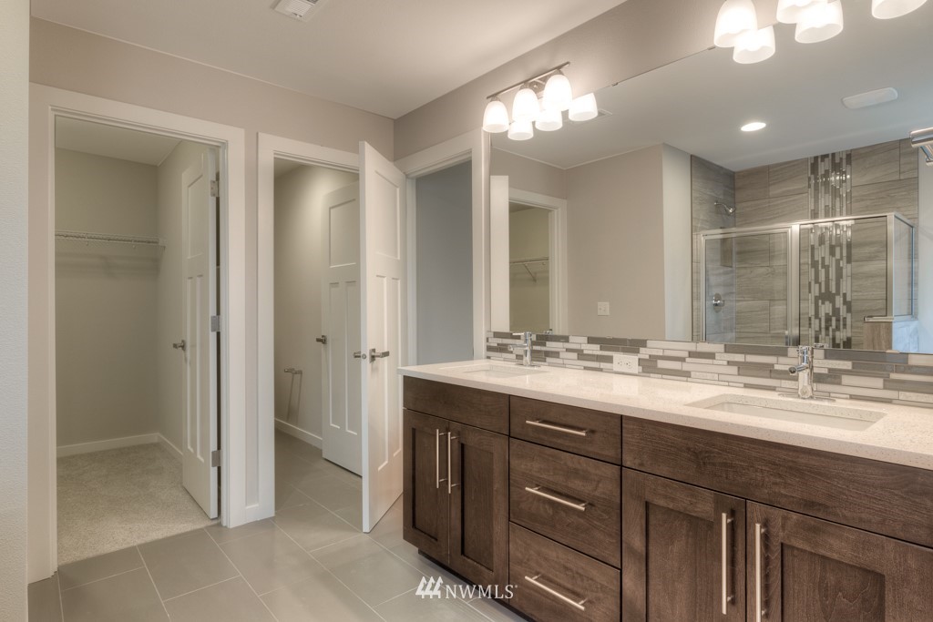 3920 242nd Street Southeast, Unit PT 4 Bothell, WA 98021 - Photo 17 of 23 a bathroom with a granite countertop sink a large mirror and a shower