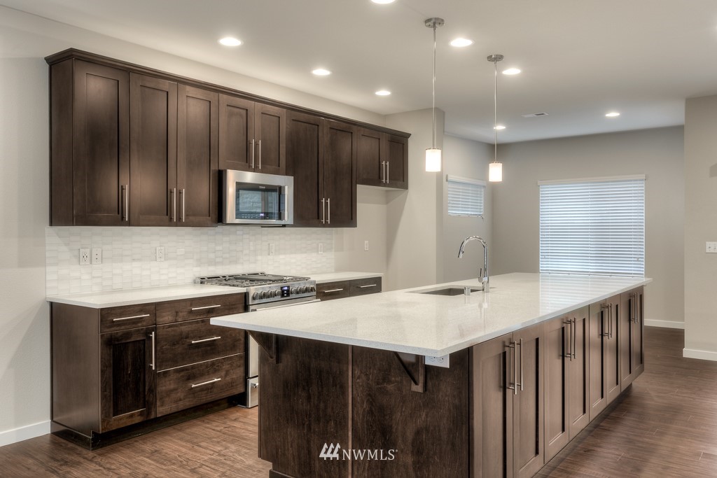 3920 242nd Street Southeast, Unit PT 4 Bothell, WA 98021 - Photo 10 of 23 a kitchen with a stove a sink and a microwave