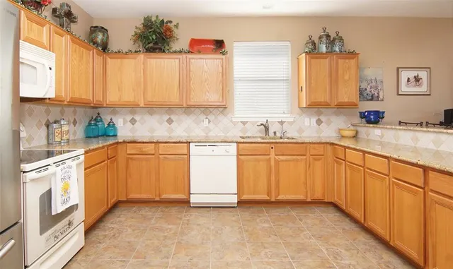 a kitchen with a sink stove and cabinets
