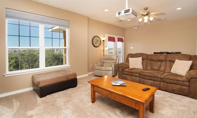 a living room with furniture a table and a large window
