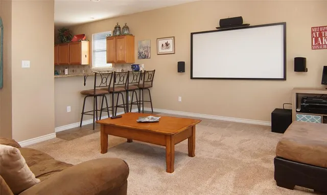 a living room with furniture a flat screen tv and paintings on the wall