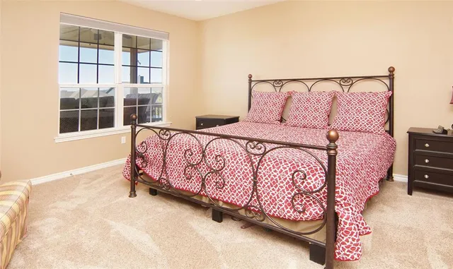 a bed sitting in a bedroom next to a window