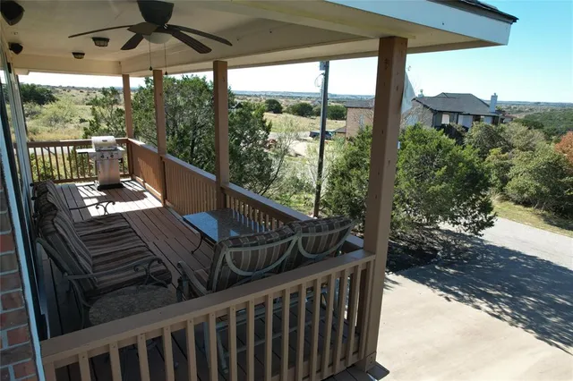 a view of balcony with wooden floor and outdoor seating