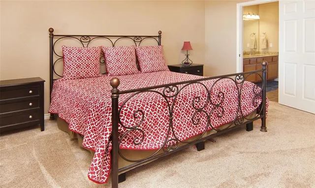 a bed sitting in a bedroom next to a window and a walk in closet