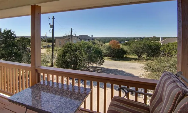 a view of a balcony with wooden floor