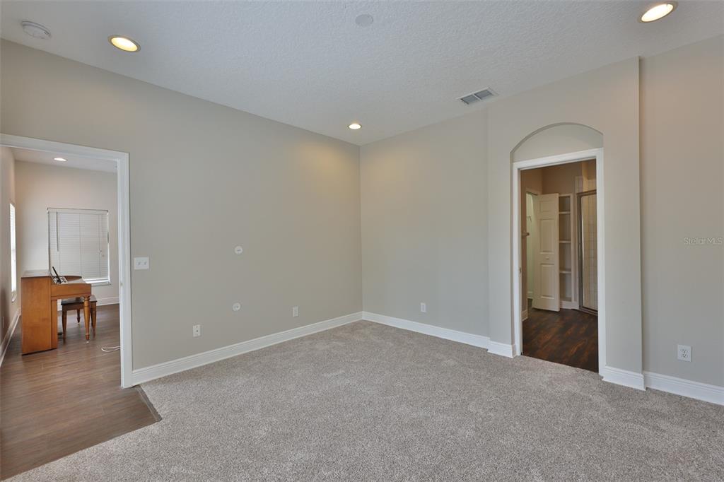 708 Coade Stone Drive Seffner, FL 33584 - Photo 4 of 48 an empty room with mirror and a table